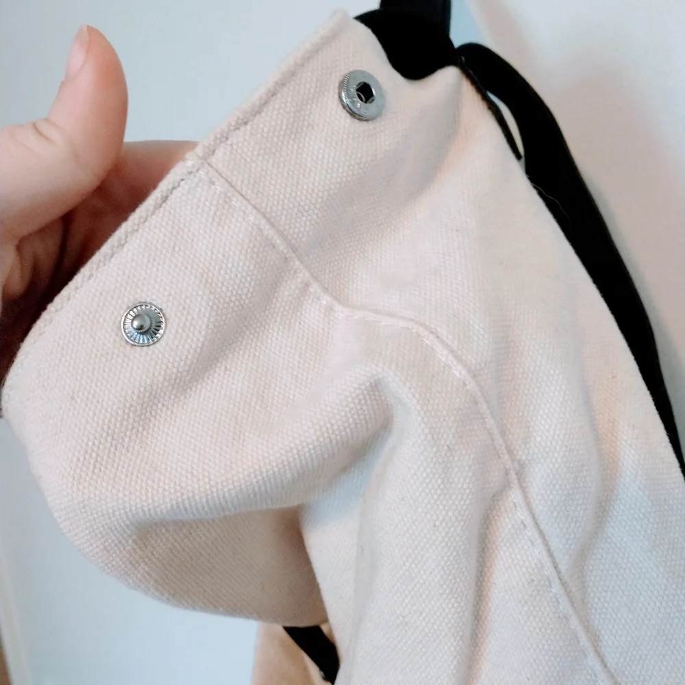 Deux Lux beige and black faux leather mini bag with buttons on the side to expan